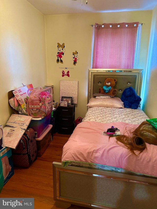 bedroom with wood-type flooring