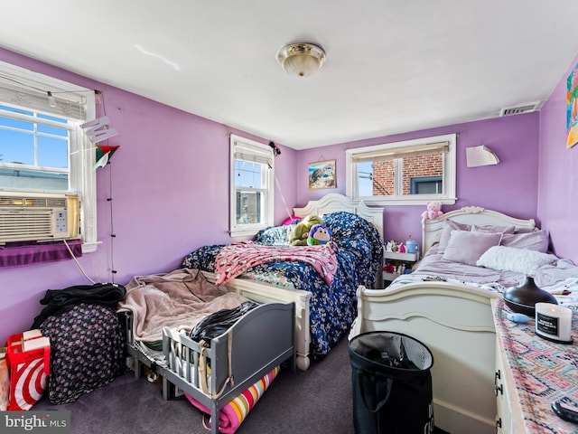 carpeted bedroom featuring multiple windows and cooling unit