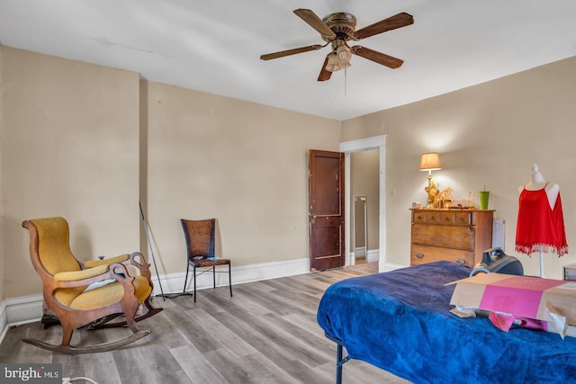 bedroom with ceiling fan and wood-type flooring