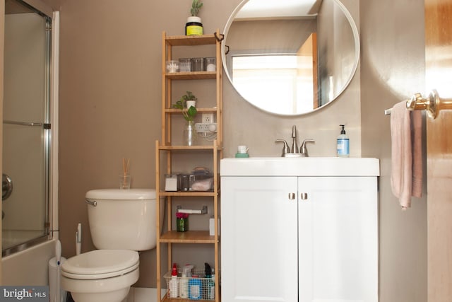 full bathroom featuring toilet, bath / shower combo with glass door, and vanity