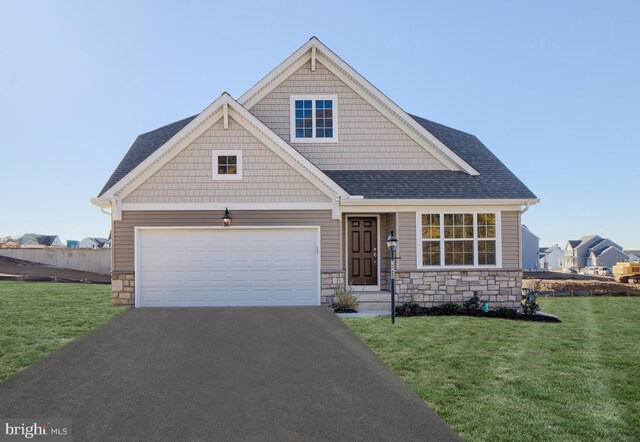 craftsman-style home with a garage and a front lawn