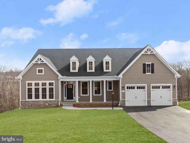 473 Orange Tree Ln, Westminster, MD 21157 - view of front of property with stone siding, driveway, a front yard, covered porch, and roof with shingles