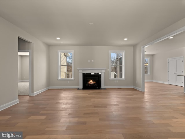 473 Orange Tree Ln, Westminster, MD 21157 - unfurnished living room with a fireplace with flush hearth, recessed lighting, light wood-type flooring, and baseboards
