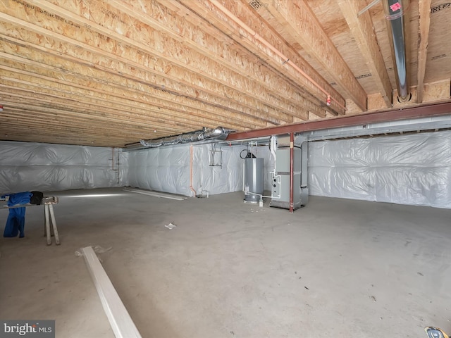 basement featuring water heater and heating unit