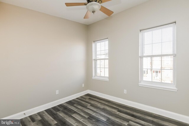 spare room with ceiling fan and dark wood-type flooring