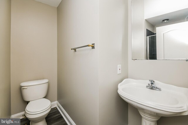 bathroom featuring sink, hardwood / wood-style floors, and toilet