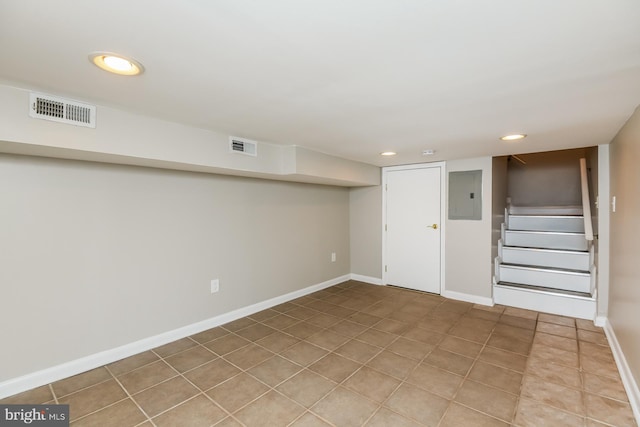 finished below grade area featuring recessed lighting, visible vents, baseboards, stairs, and electric panel