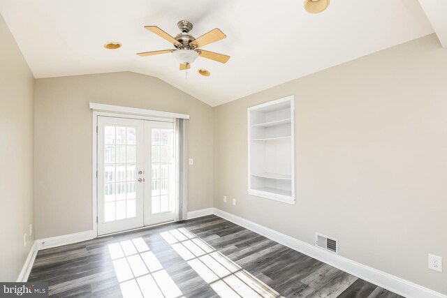 empty room featuring hardwood / wood-style flooring, french doors, built in features, and ceiling fan