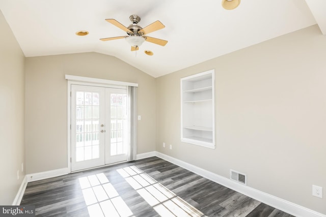 unfurnished room with built in features, french doors, lofted ceiling, visible vents, and baseboards