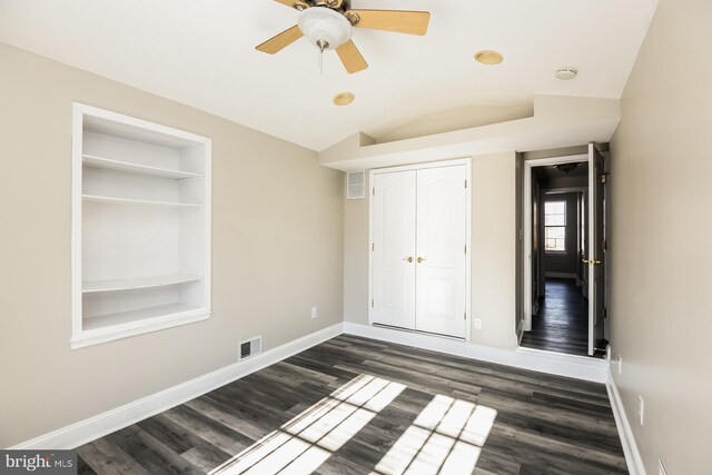 unfurnished bedroom with ceiling fan, dark hardwood / wood-style flooring, and lofted ceiling