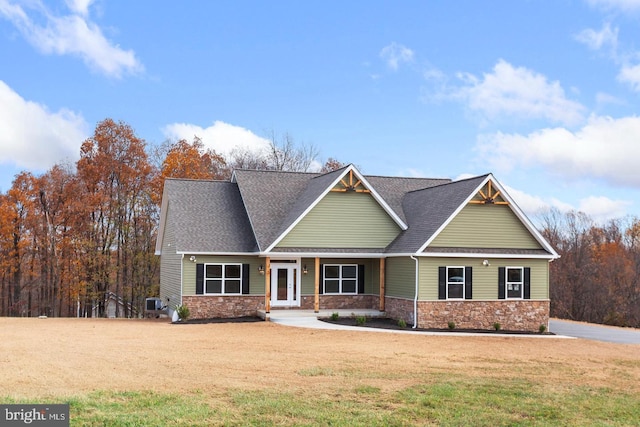 craftsman inspired home with a front lawn