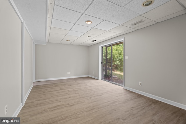 unfurnished room featuring a paneled ceiling and hardwood / wood-style flooring