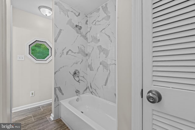 bathroom with tile patterned floors and tiled shower / bath