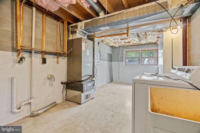 basement with washing machine and dryer and heating unit