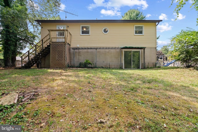 rear view of property with a yard