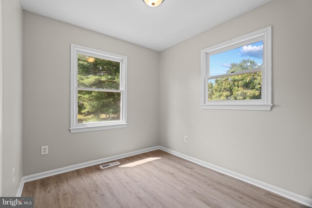 unfurnished bedroom featuring a closet and light hardwood / wood-style flooring