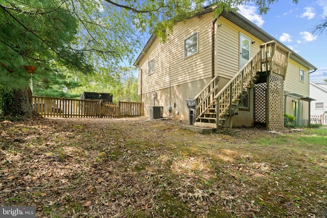 rear view of house featuring central AC