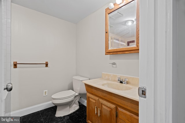 bathroom with tile patterned flooring, vanity, and toilet