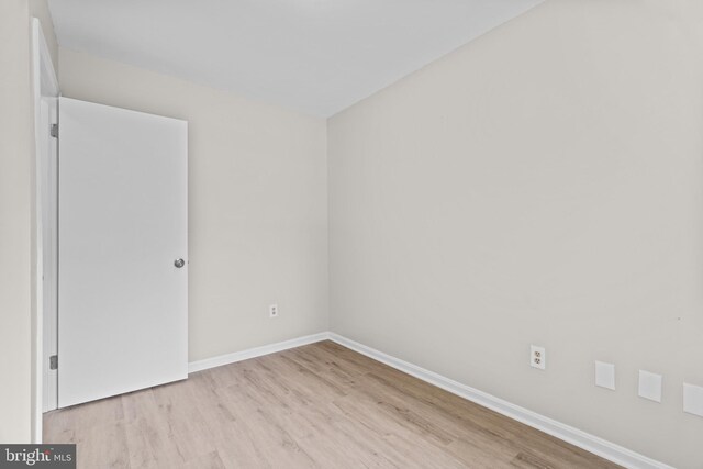 interior space featuring a drop ceiling and light hardwood / wood-style flooring