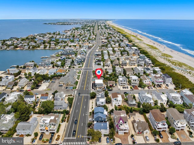 bird's eye view with a water view and a view of the beach