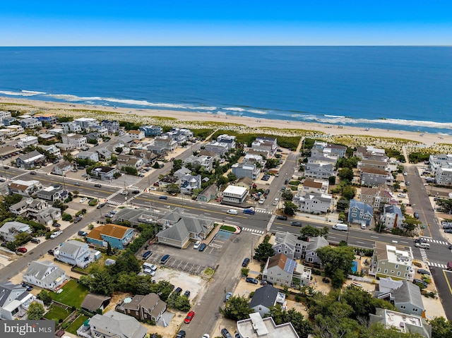 drone / aerial view featuring a beach view and a water view