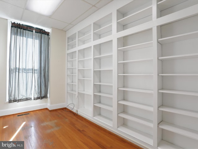 unfurnished room featuring a paneled ceiling and hardwood / wood-style flooring