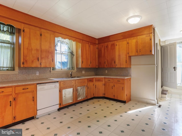 kitchen with dishwasher, sink, and decorative backsplash