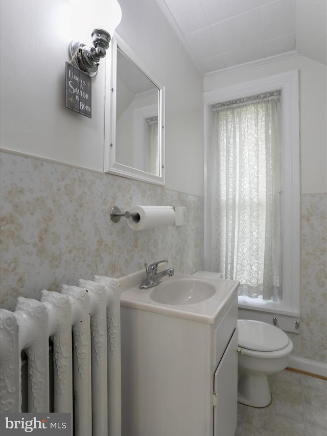 bathroom with crown molding, vanity, toilet, and tile patterned floors