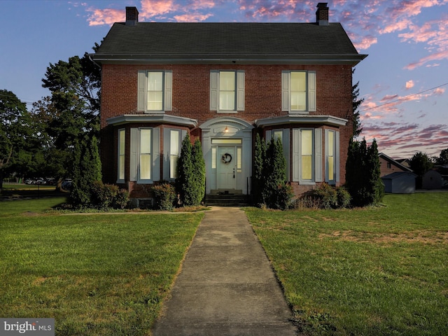 view of front of property with a yard