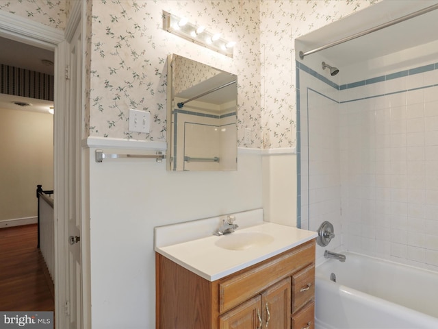 bathroom featuring vanity, tiled shower / bath, and hardwood / wood-style flooring