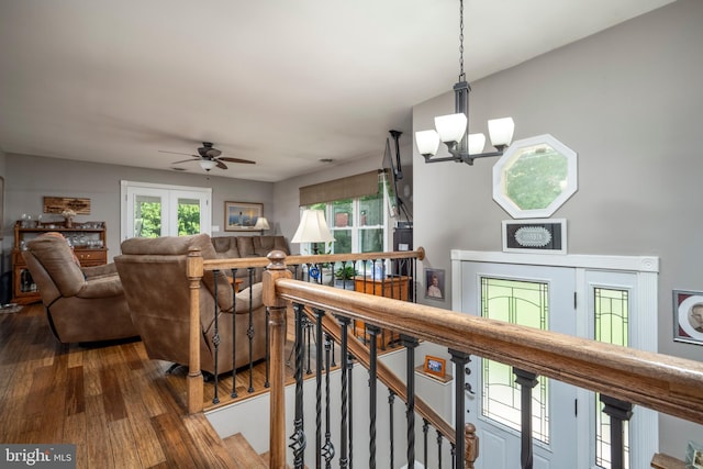 interior space featuring ceiling fan with notable chandelier and wood finished floors