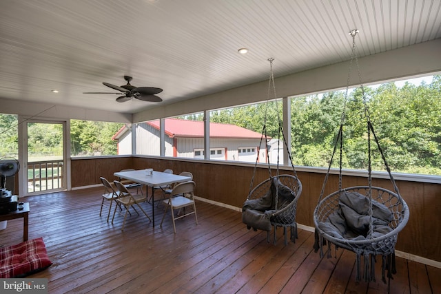 sunroom / solarium with ceiling fan and a healthy amount of sunlight