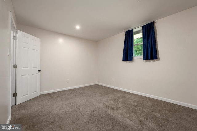 carpeted empty room featuring baseboards and recessed lighting