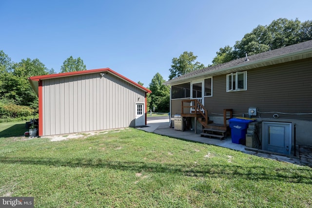 back of house featuring a sunroom and a lawn