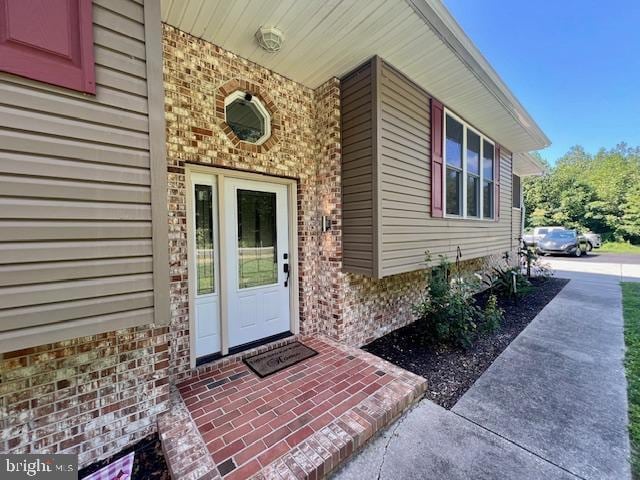 entrance to property with brick siding