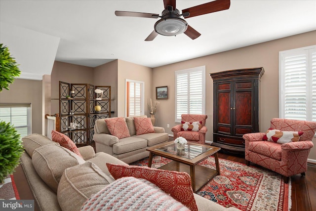 living room with baseboards, a ceiling fan, and wood finished floors