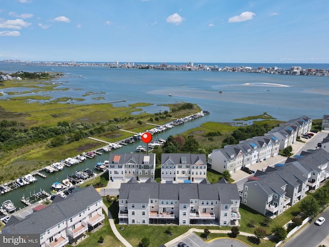 drone / aerial view featuring a water view and a residential view