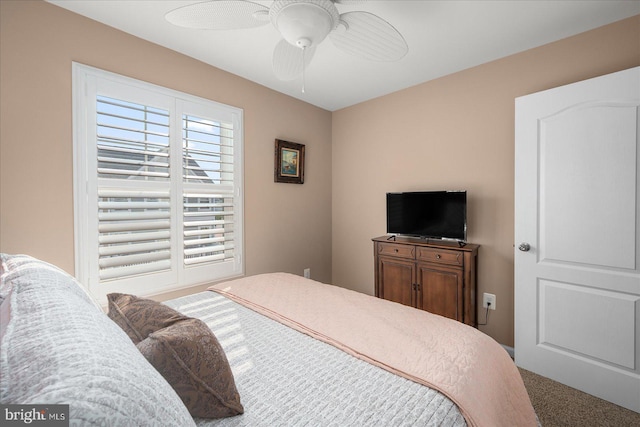 carpeted bedroom with a ceiling fan