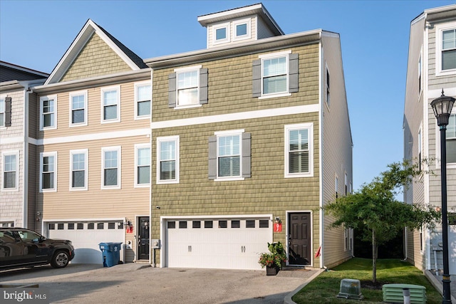 view of property featuring driveway and an attached garage