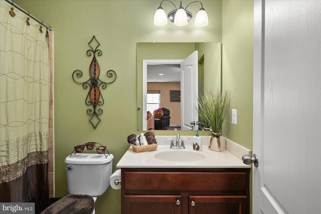 bathroom with vanity, a shower with shower curtain, and toilet