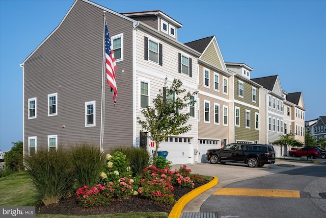 multi unit property featuring a residential view and a garage