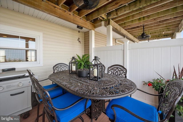 view of patio with ceiling fan and fence