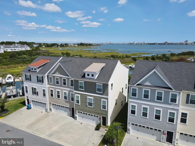 drone / aerial view with a residential view and a water view