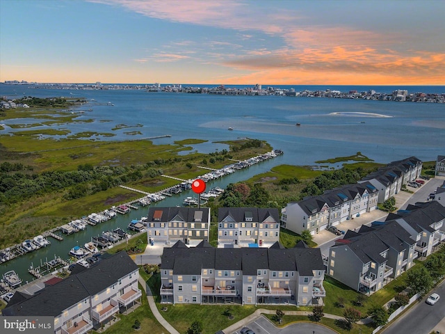 drone / aerial view with a water view and a residential view