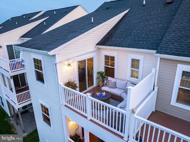 back of house featuring an outdoor hangout area and roof with shingles