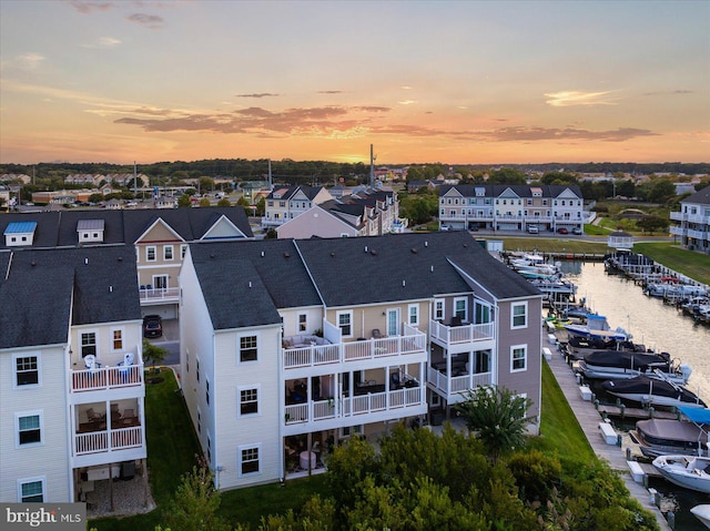 birds eye view of property with a water view and a residential view