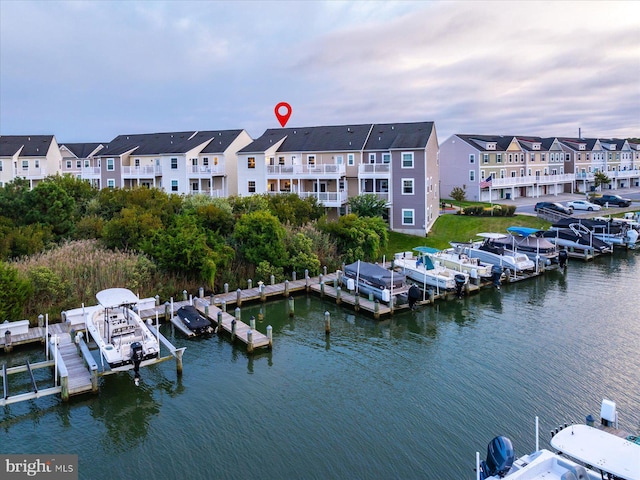 exterior space featuring a water view, boat lift, and a residential view