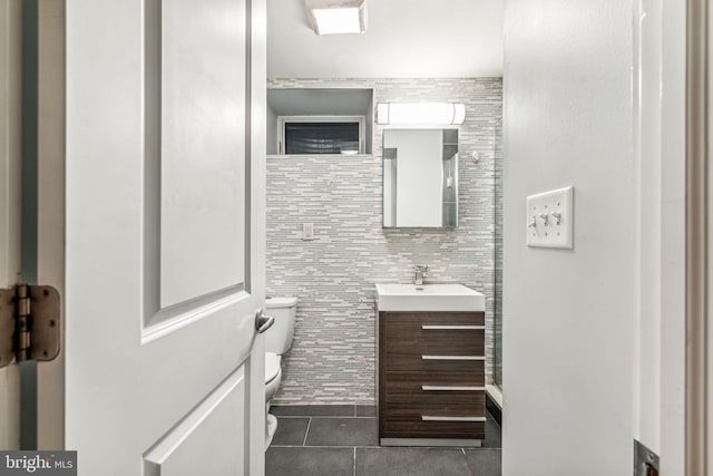 bathroom featuring tile walls, tile patterned flooring, vanity, and toilet