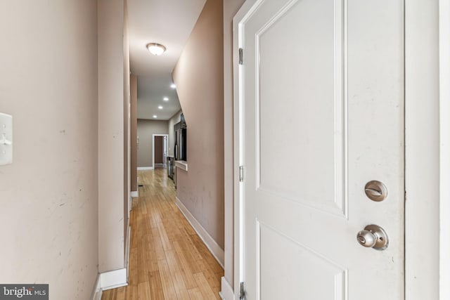 hallway with light hardwood / wood-style floors