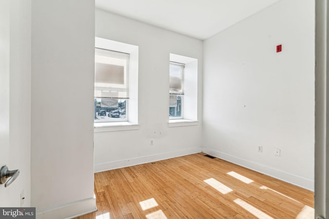 unfurnished room with light hardwood / wood-style flooring